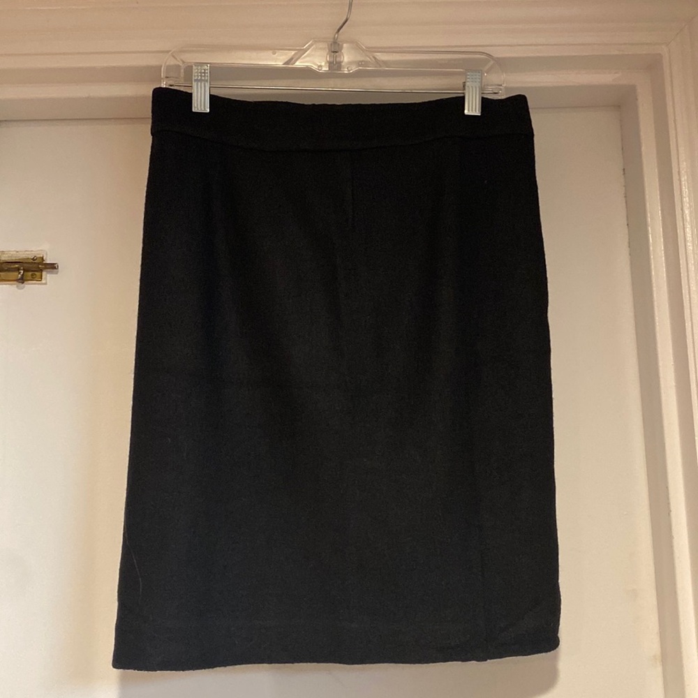 Banana Republic black wool pencil skirt with gold zipper along the back, size 8.